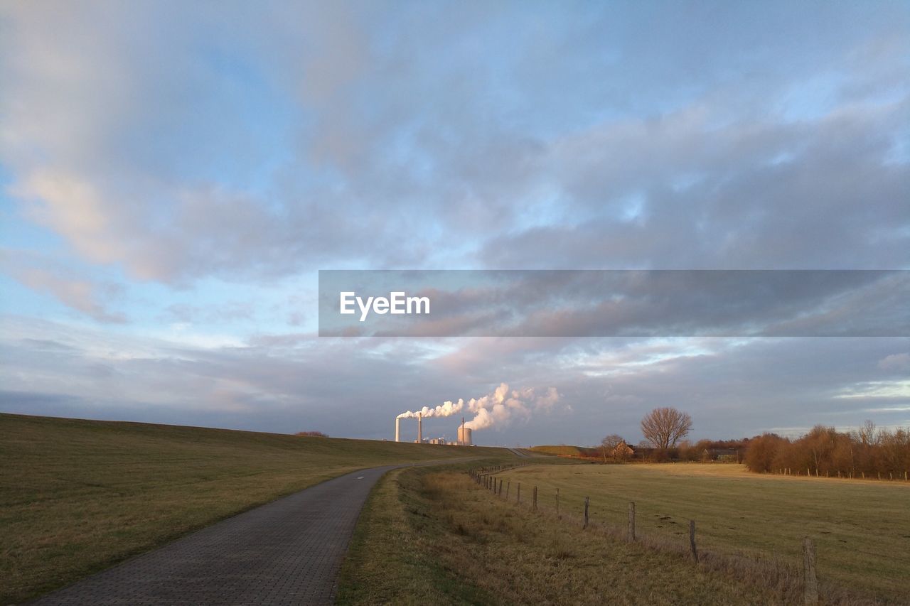 SCENIC VIEW OF DRAMATIC LANDSCAPE AGAINST STORM CLOUDS