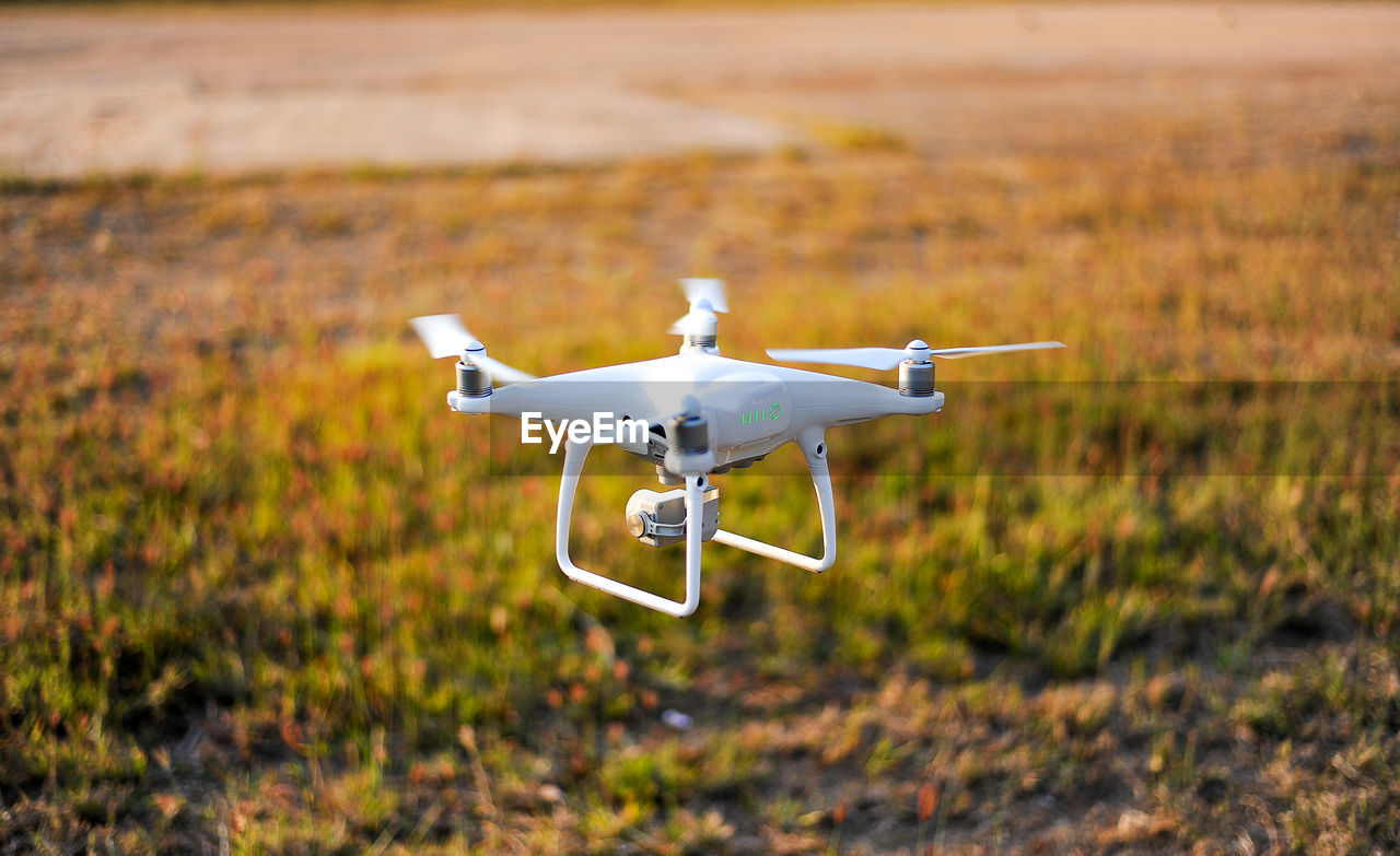 Drone flying over field