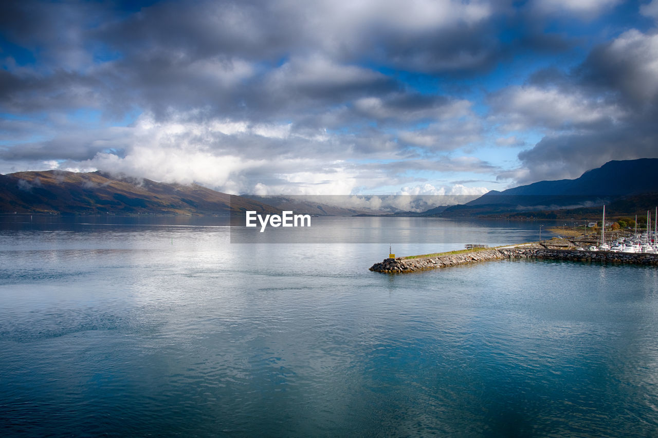 water, reflection, cloud, sky, sea, scenics - nature, mountain, beauty in nature, horizon, nature, dusk, nautical vessel, environment, landscape, ocean, transportation, travel destinations, tranquility, travel, land, tranquil scene, morning, no people, blue, mountain range, body of water, bay, outdoors, dramatic sky, beach, mode of transportation, coast, cloudscape, vehicle, ship, day, tourism, architecture, holiday, sunlight