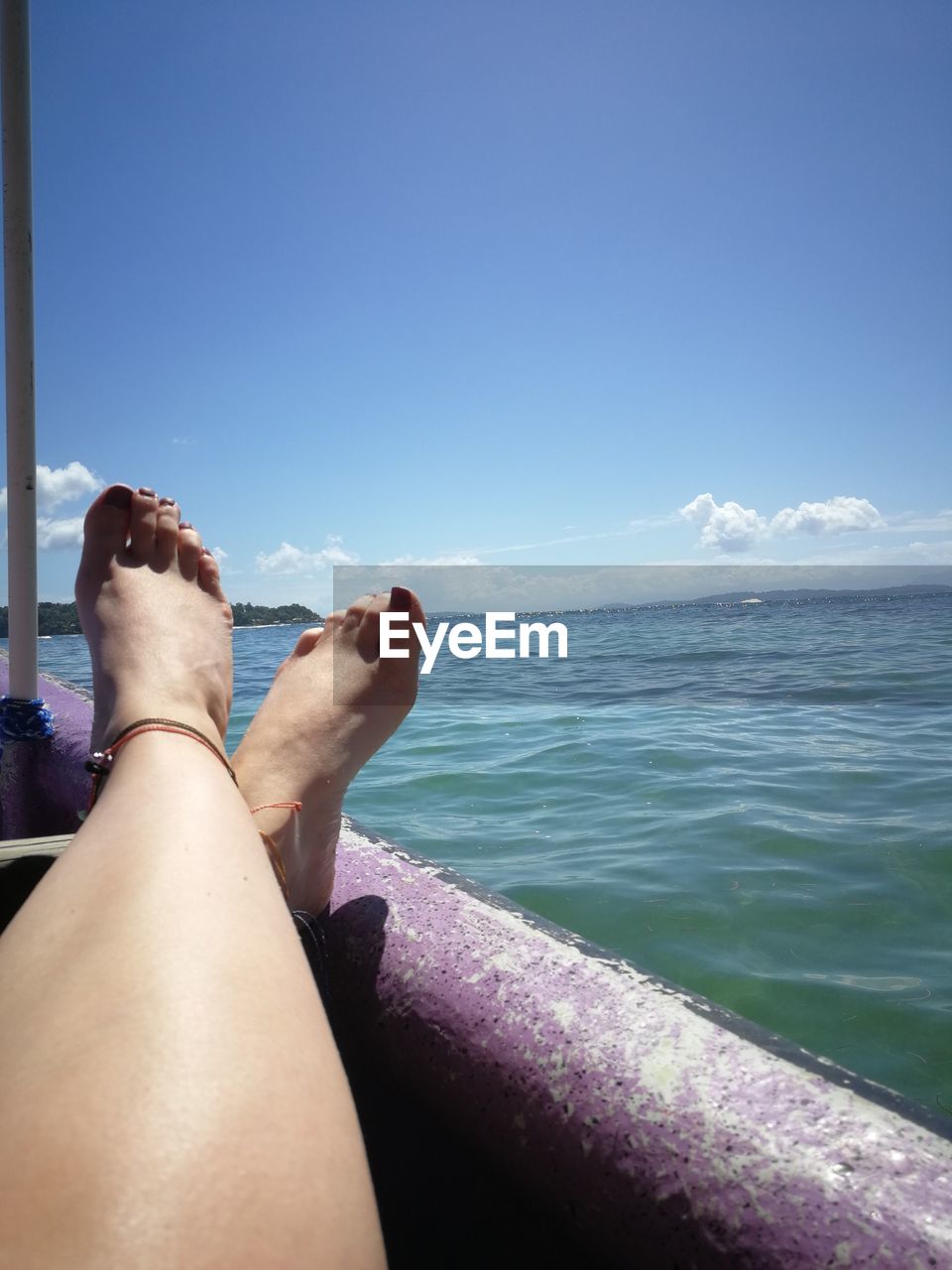 water, sea, human leg, one person, sky, relaxation, adult, holiday, low section, vacation, ocean, nature, trip, leisure activity, personal perspective, limb, human limb, women, travel, lifestyles, day, blue, human foot, barefoot, sunlight, beach, land, horizon, beauty in nature, clear sky, summer, scenics - nature, travel destinations, resting, outdoors, horizon over water, tranquility, copy space, lying down, sunny, sitting, shore, tranquil scene, legs crossed at ankle, hand, coast, idyllic