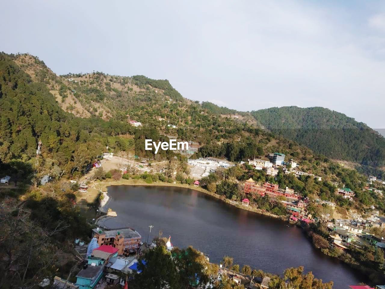 High angle view of river amidst trees against sky