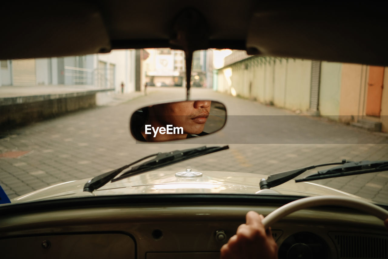 Young man in car on street