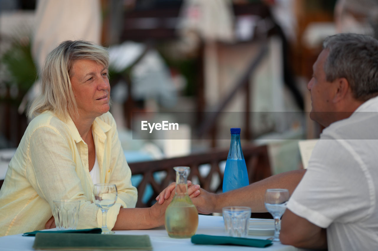 Mature couple sitting at restaurant table