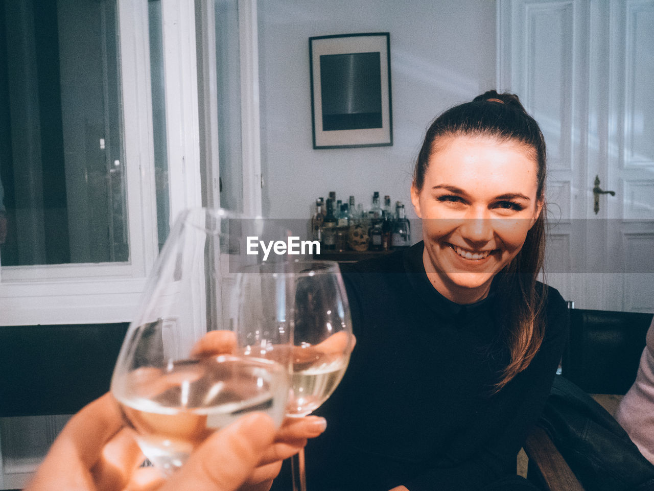 Portrait of happy woman toasting wine at restaurant