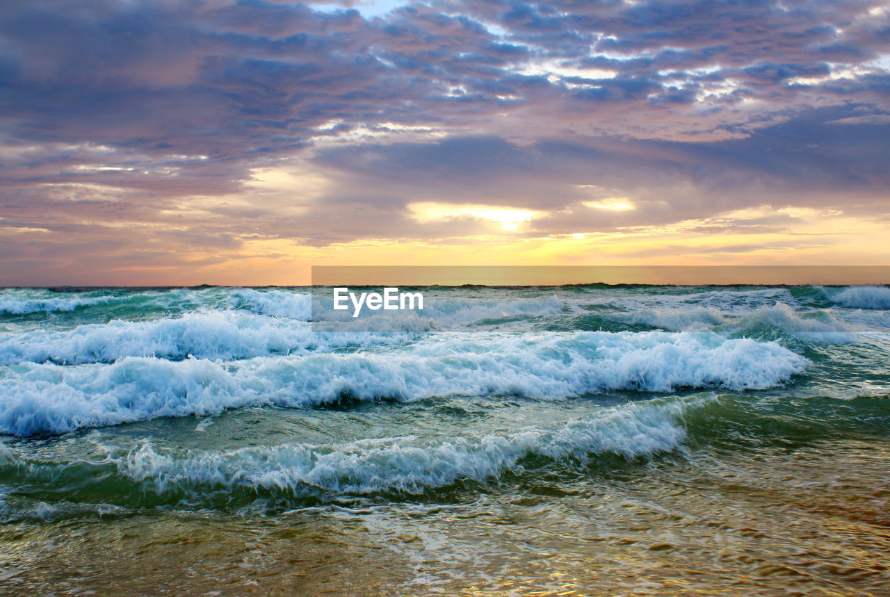 Beautiful sunset on the beach. the surf pounds the shore. phuket, thailand