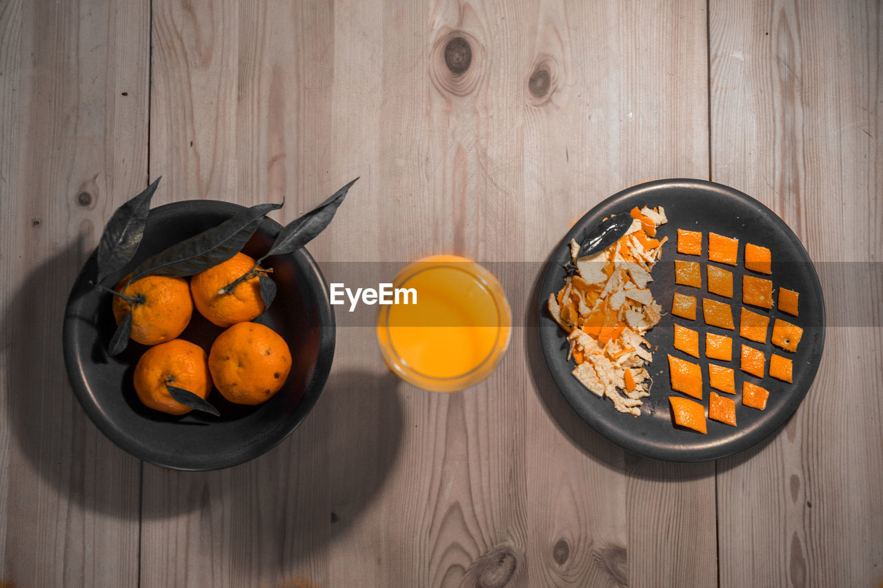 Directly above shot of oranges with juice and peel on table