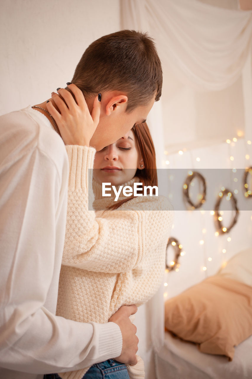 A young couple in love in a photo studio. christmas scenery, guy and girl love each other. 
