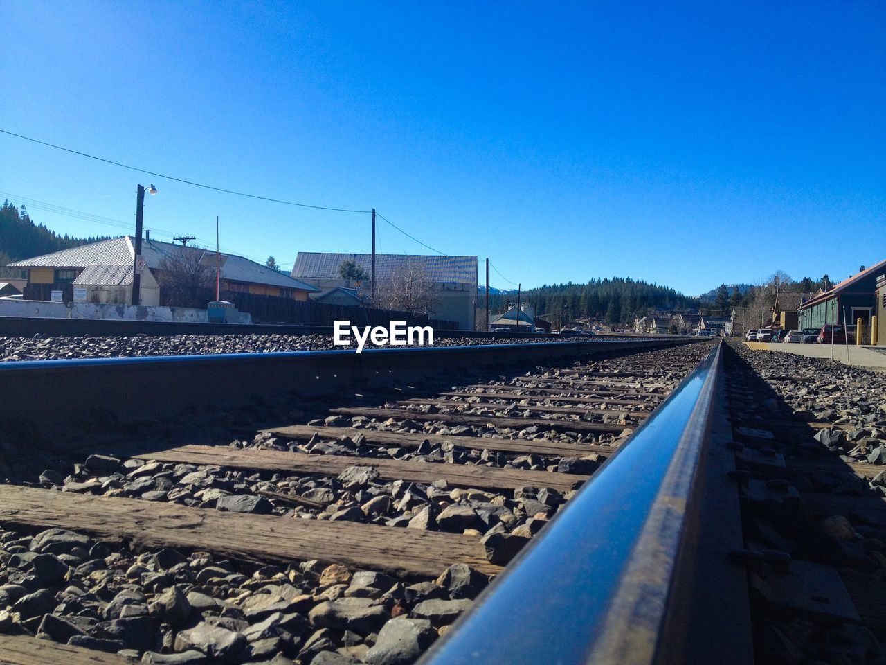 Railroad track against clear blue sky