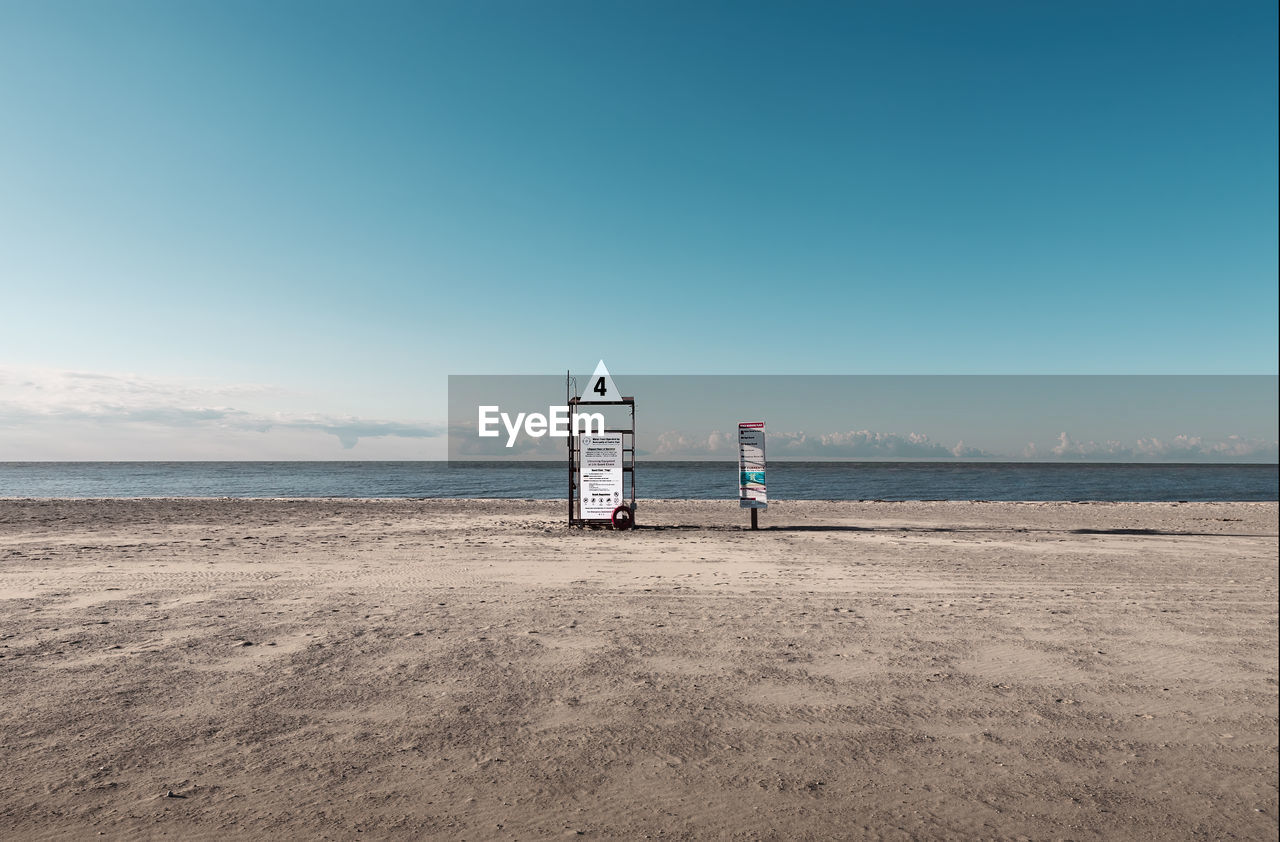 A deserted lifeguard station photographed on a quiet desolate sunny day.