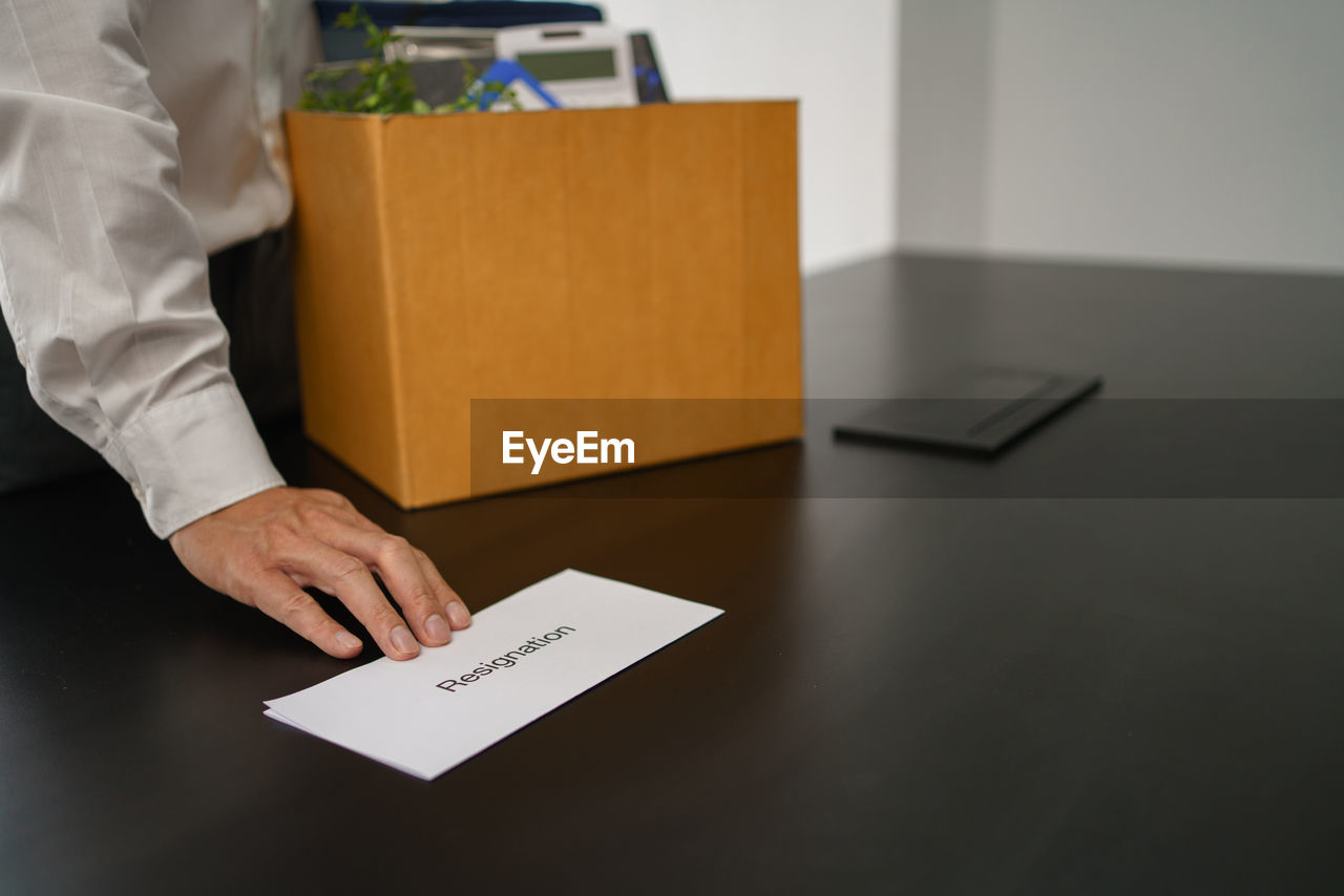 midsection of man using digital tablet on table