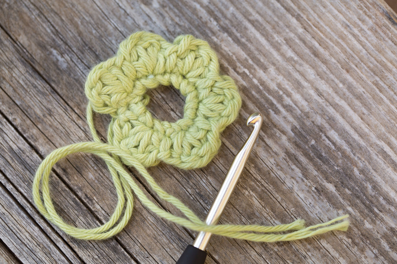 High angle view of wool with flower on table