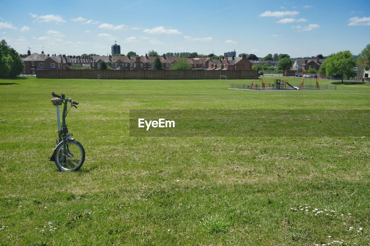 Bicycle parked on grassy field