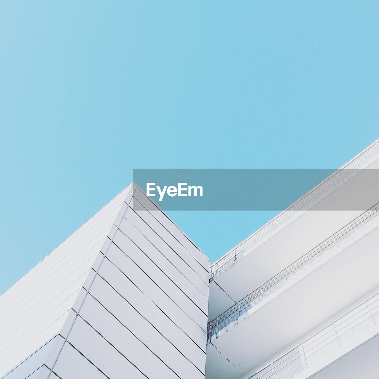 Low angle view of modern building against clear blue sky