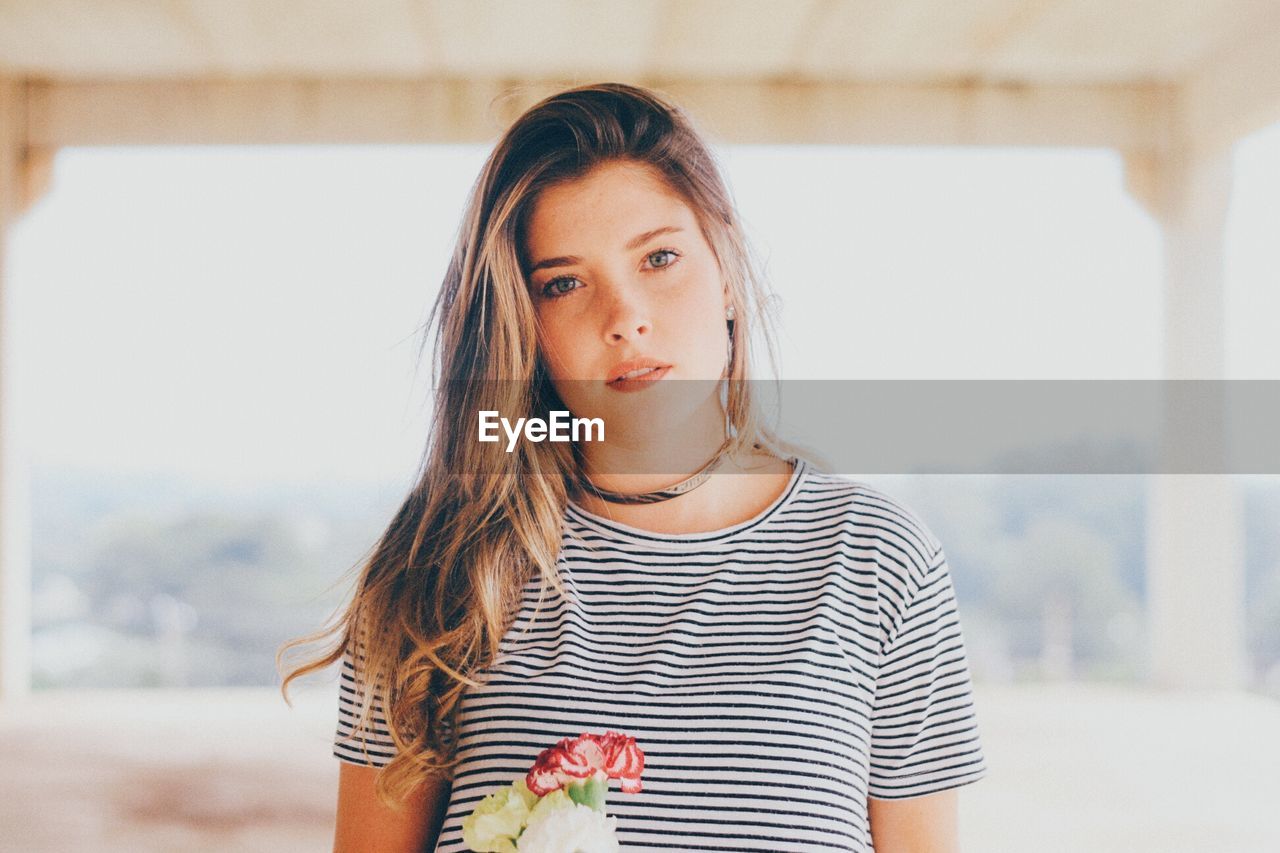 Portrait of beautiful young woman at home