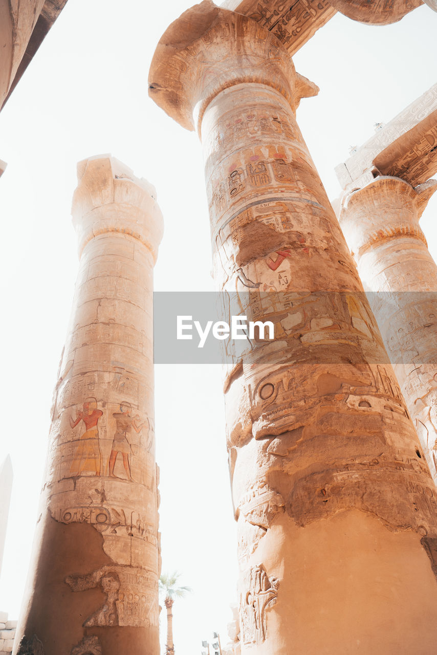 low angle view of man standing by column