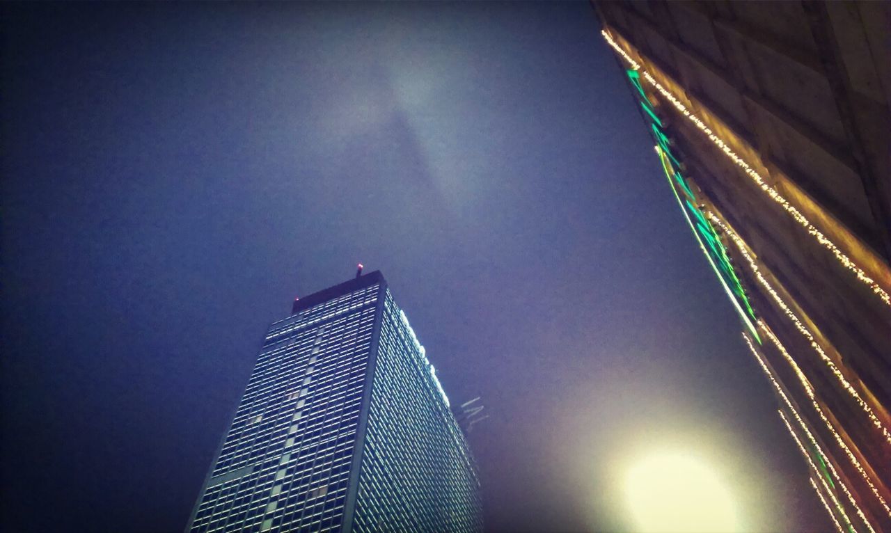 LOW ANGLE VIEW OF ILLUMINATED SKYSCRAPERS