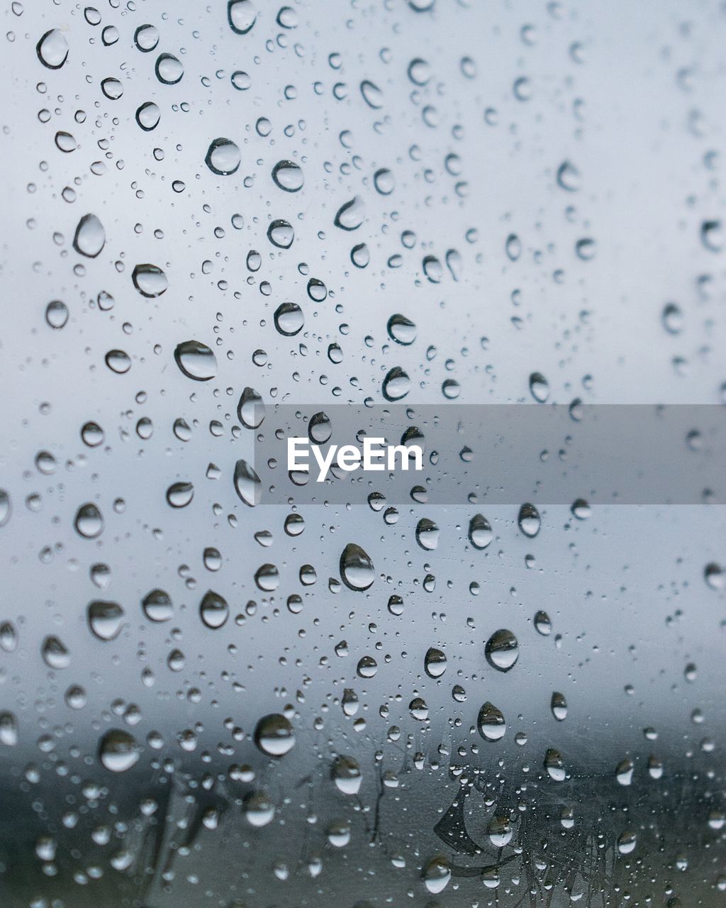 FULL FRAME SHOT OF RAINDROPS ON WINDOW