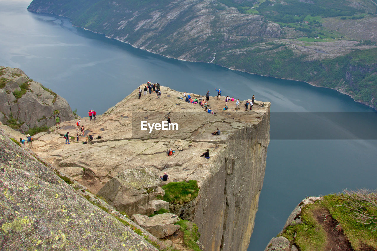 High angle view of people on cliff by river