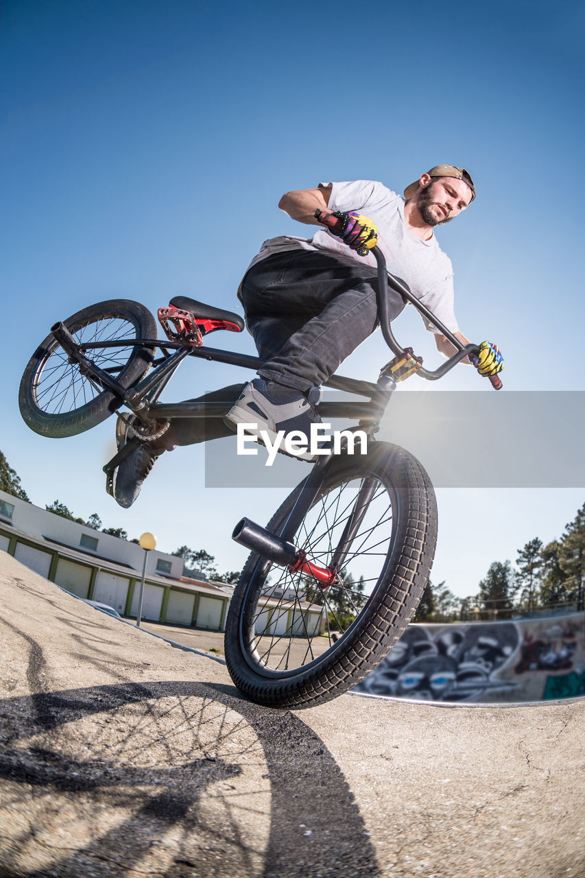 low angle view of man riding bicycle