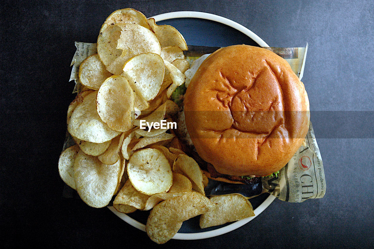 High angle view of burger and chips on table