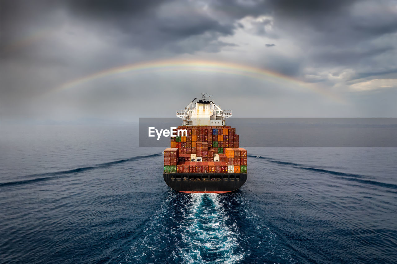 Scenic view of rainbow over sea against sky