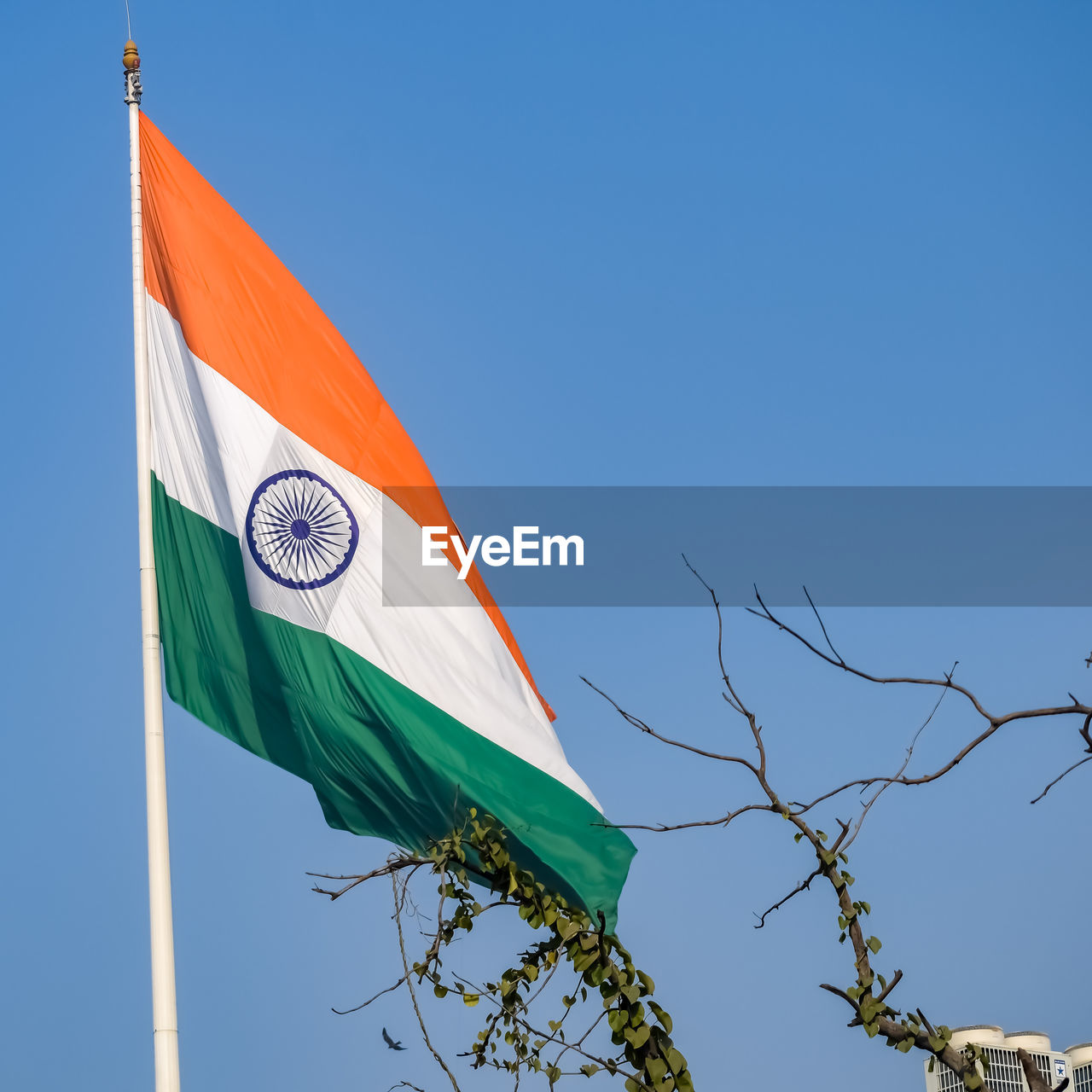 India flag flying high at connaught place with pride in blue sky, india flag fluttering, indian flag