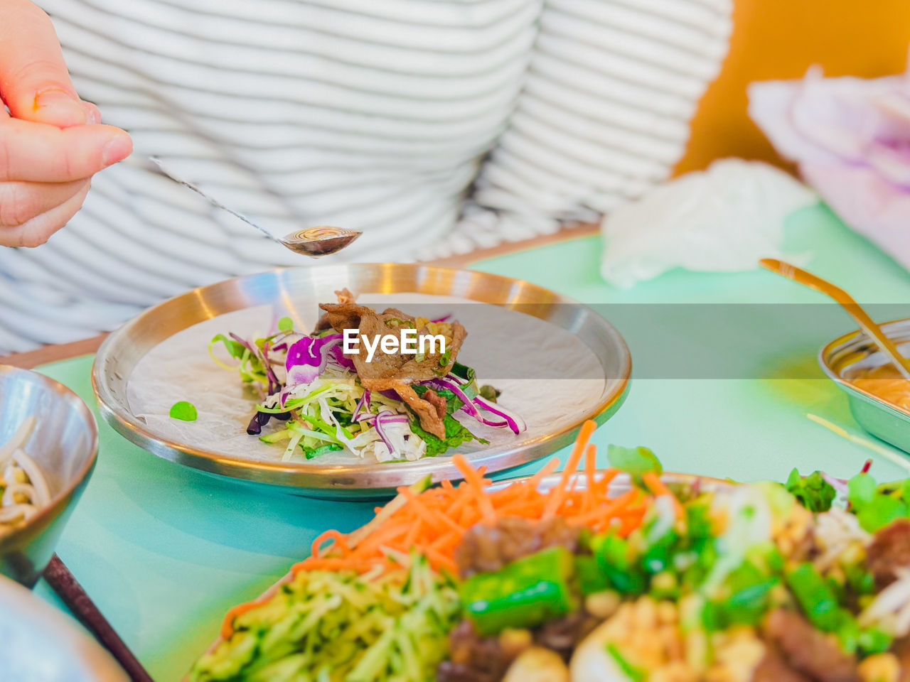 cropped hand of person having food on table