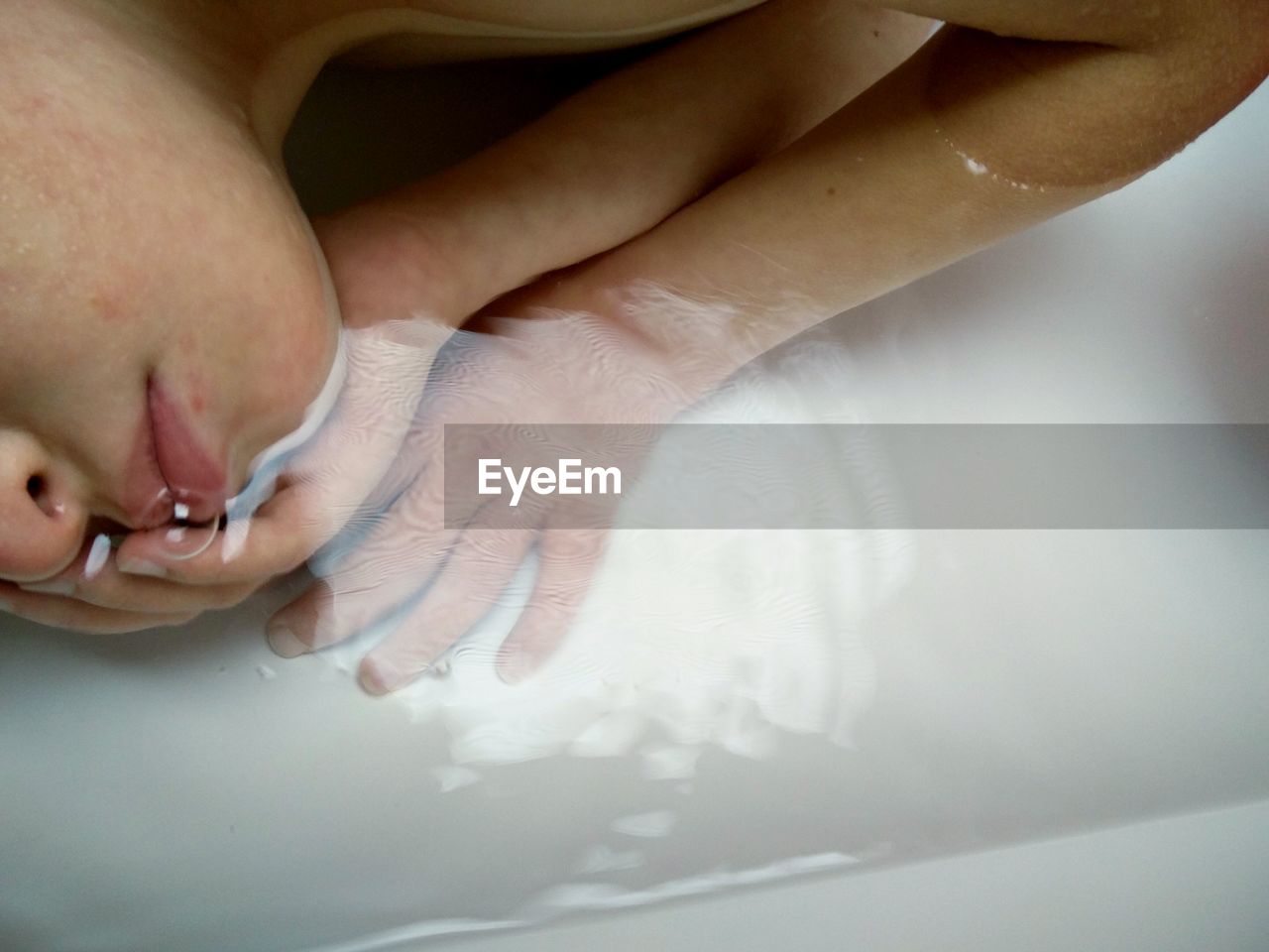 Close-up of boy relaxing in bathtub