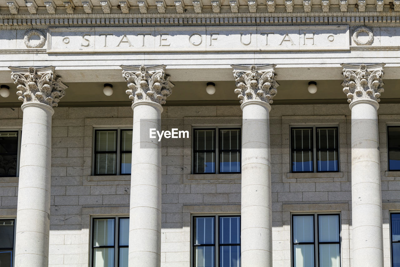 The architecture of buildings windows, stucco molding, and columns on a sunny day in the usa