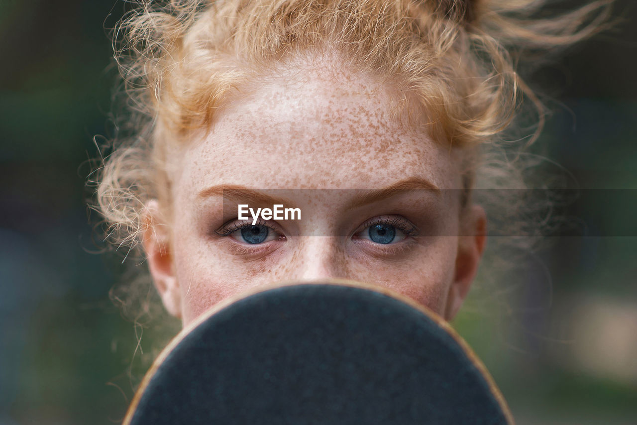 Close-up portrait of young woman standing outdoors