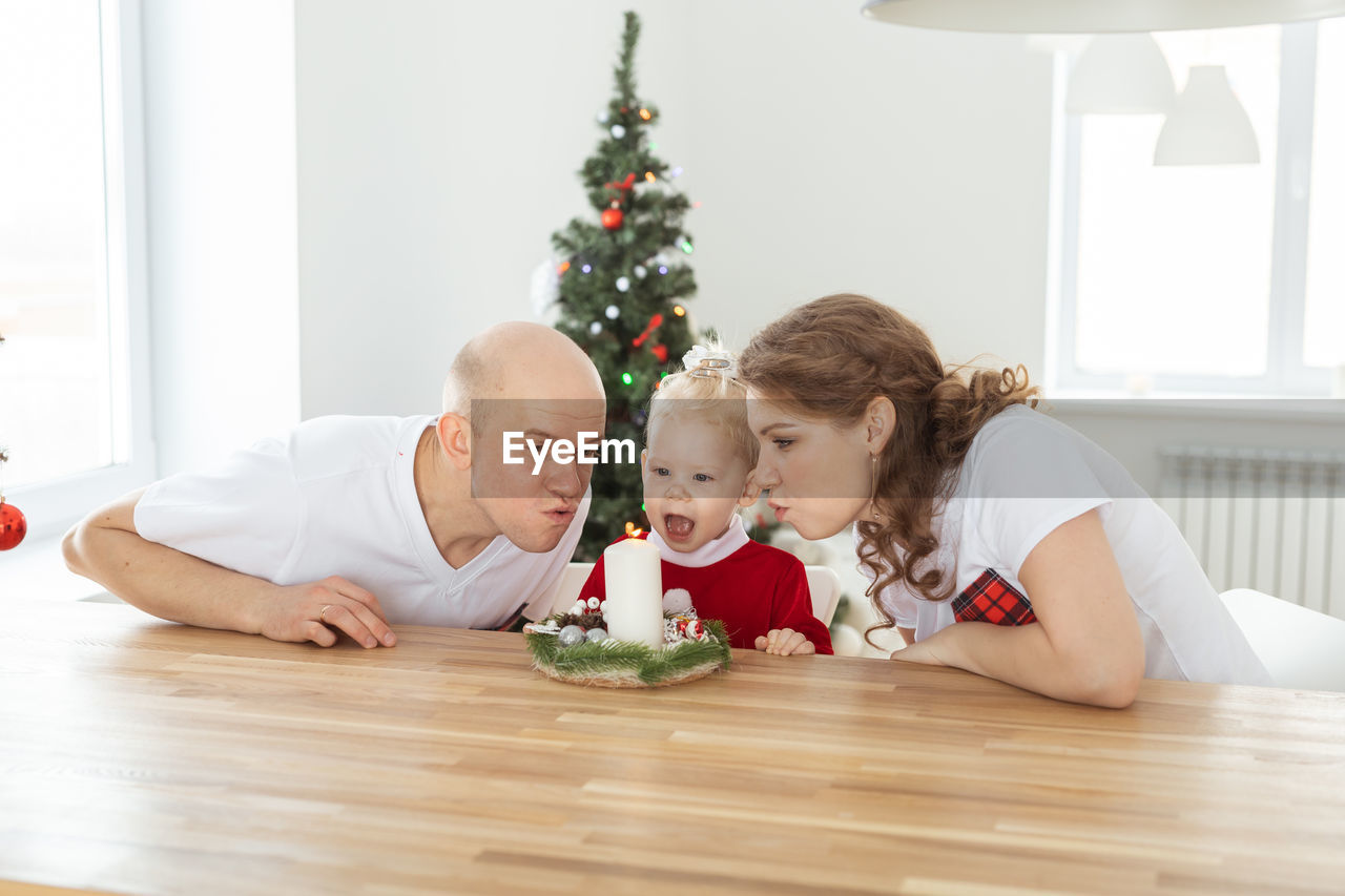 Couple with daughter at home during christmas