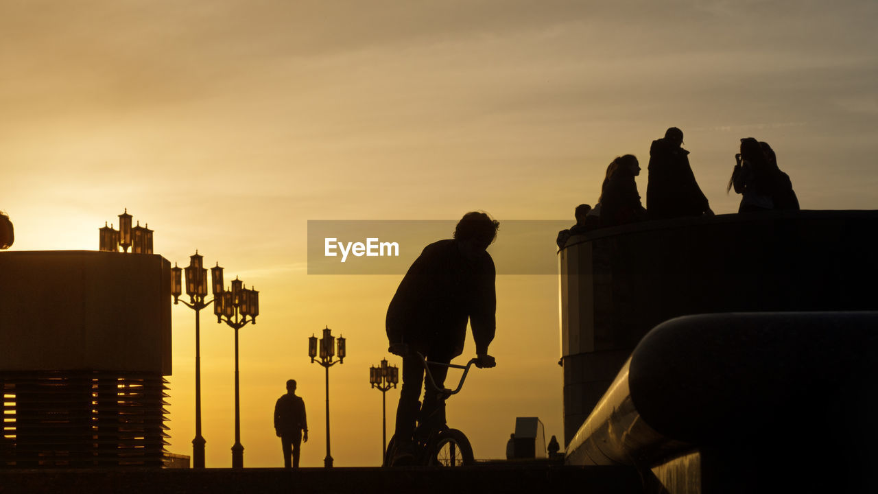 SILHOUETTE PEOPLE AGAINST SKY DURING SUNSET