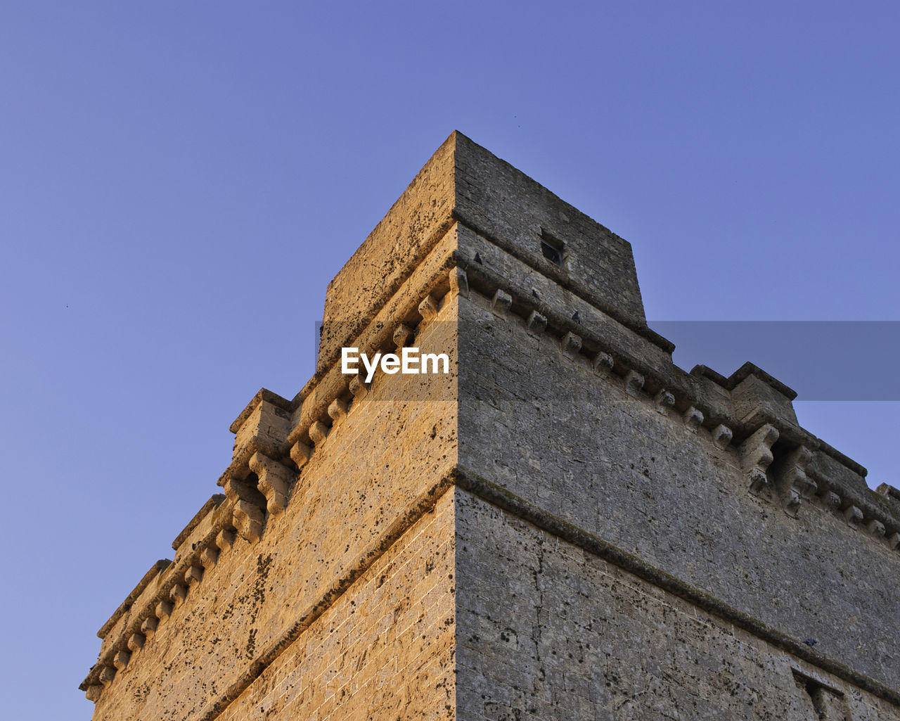 LOW ANGLE VIEW OF TEMPLE AGAINST CLEAR BLUE SKY