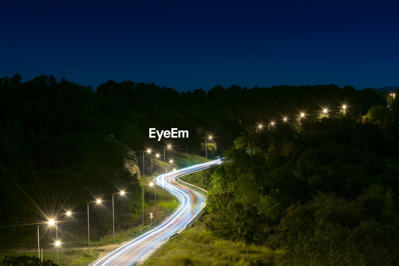 High angle view of light trails on road at night