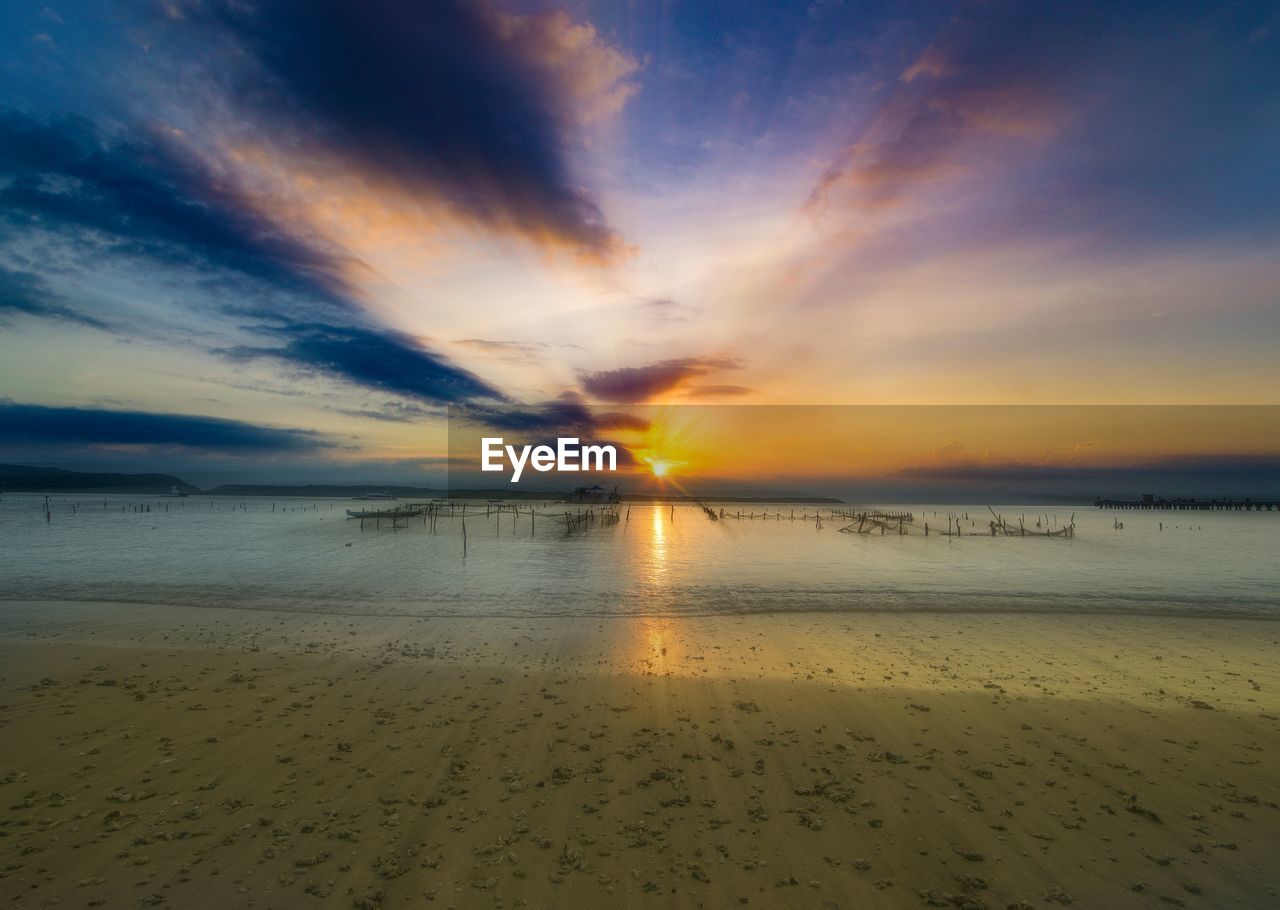 Scenic view of sea against sky at sunset