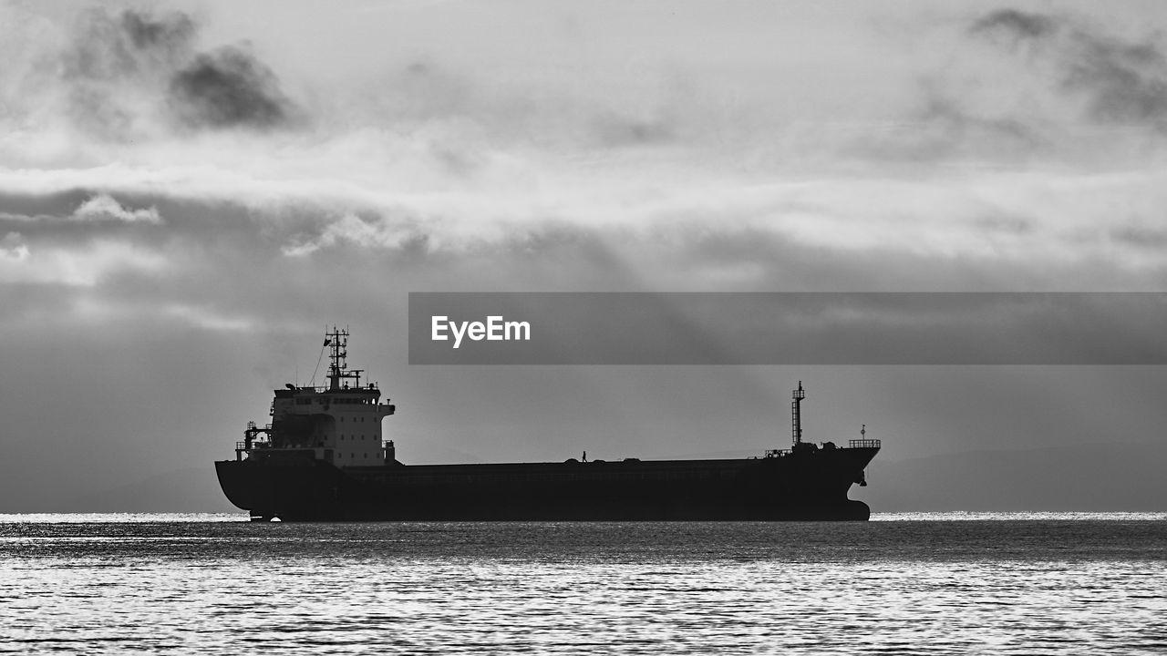 Ship sailing on sea against sky