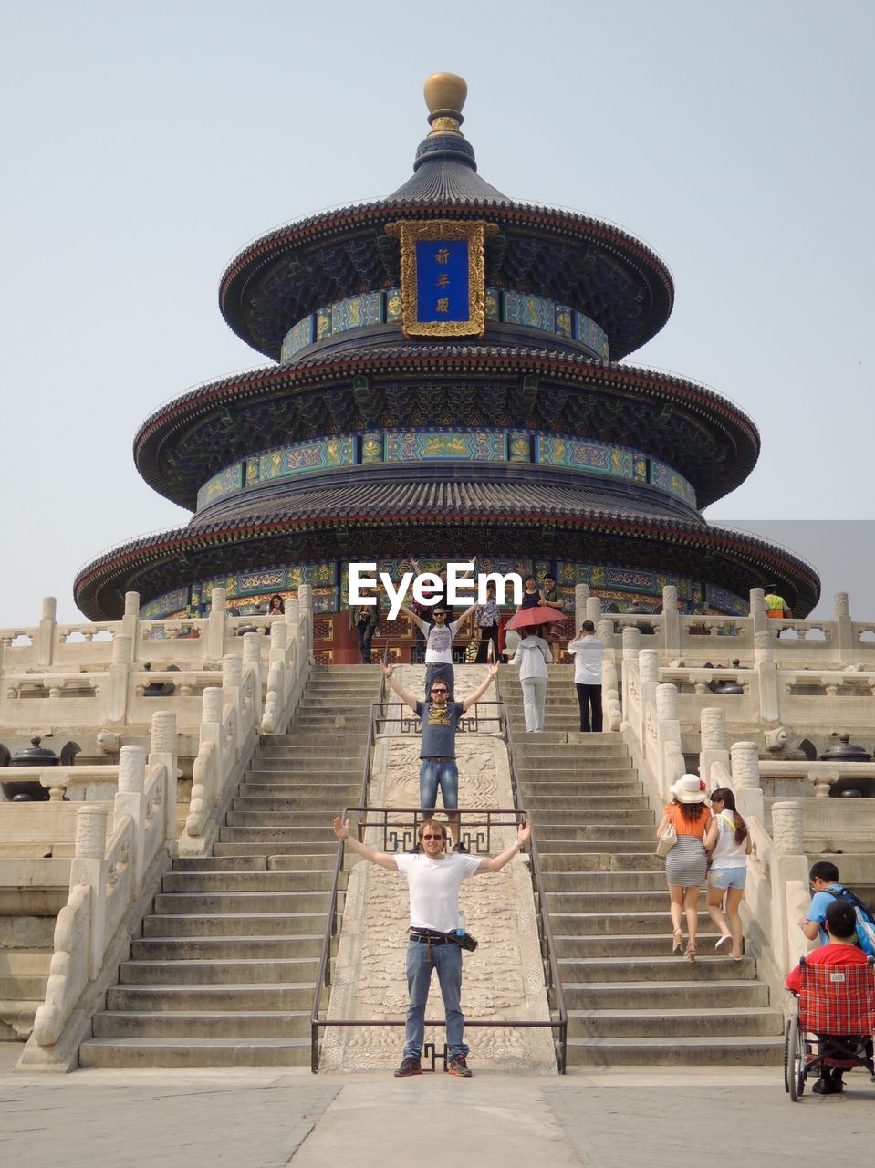 PEOPLE ON STEPS OF TEMPLE AGAINST SKY