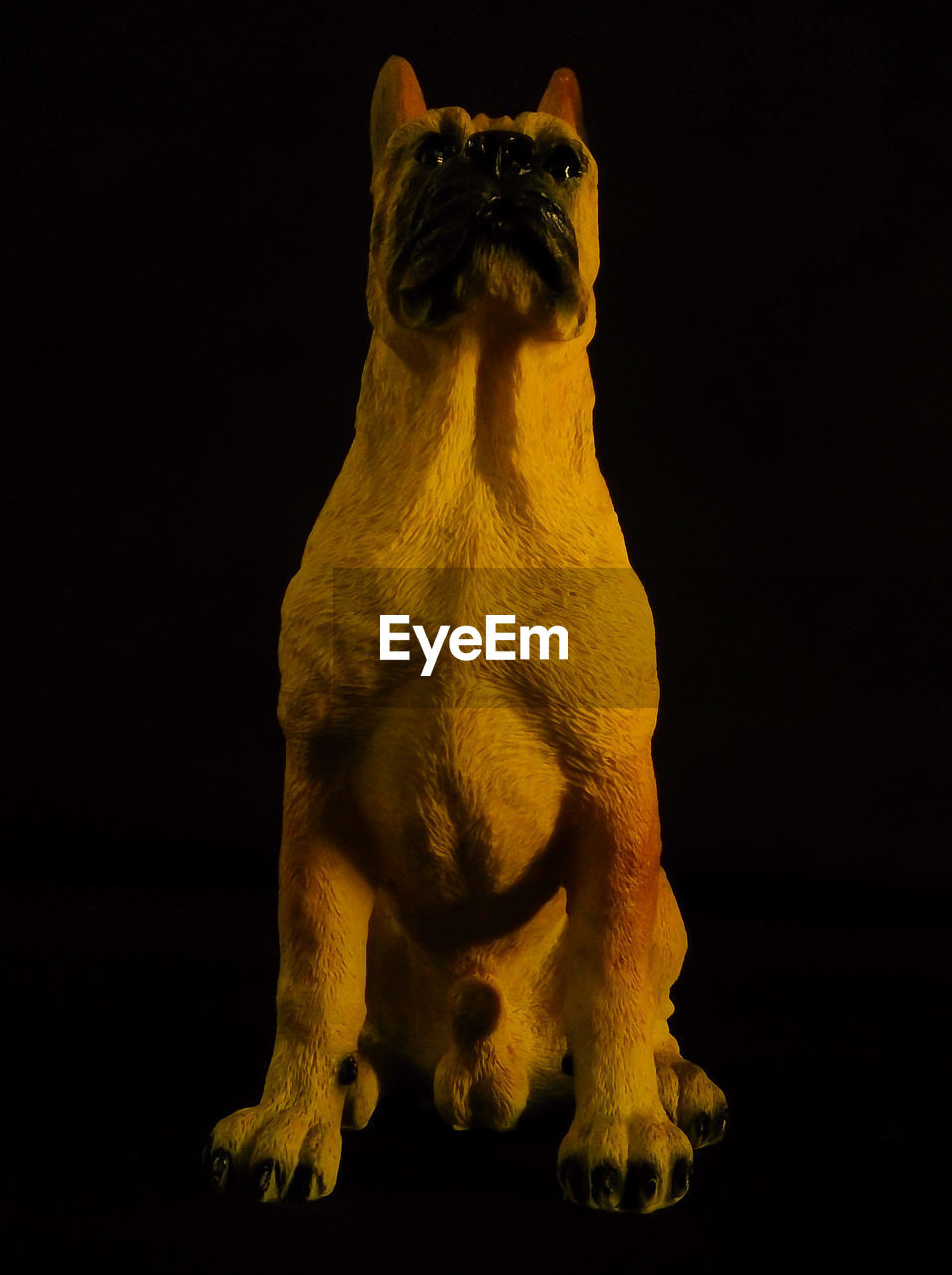 Statue of boxer against black background