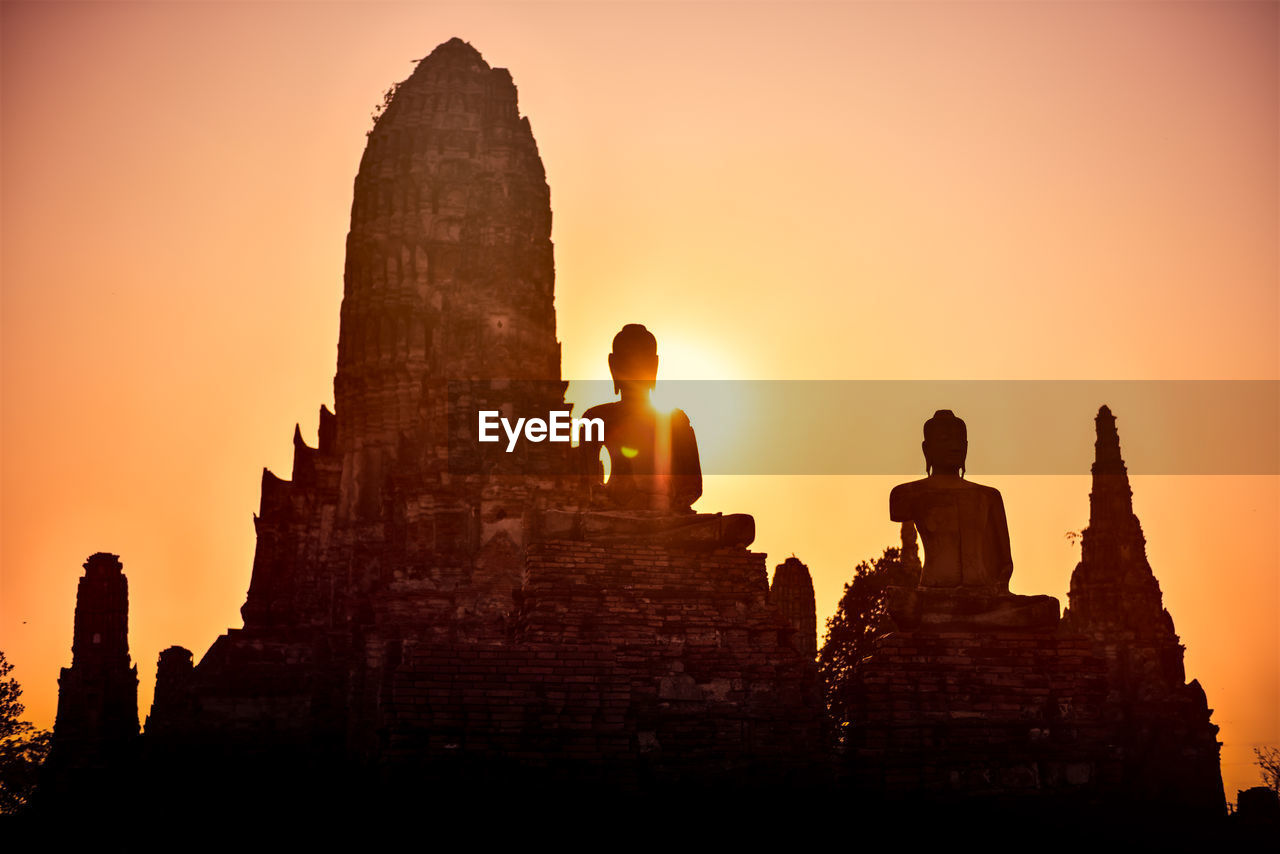 LOW ANGLE VIEW OF TEMPLE AT SUNSET