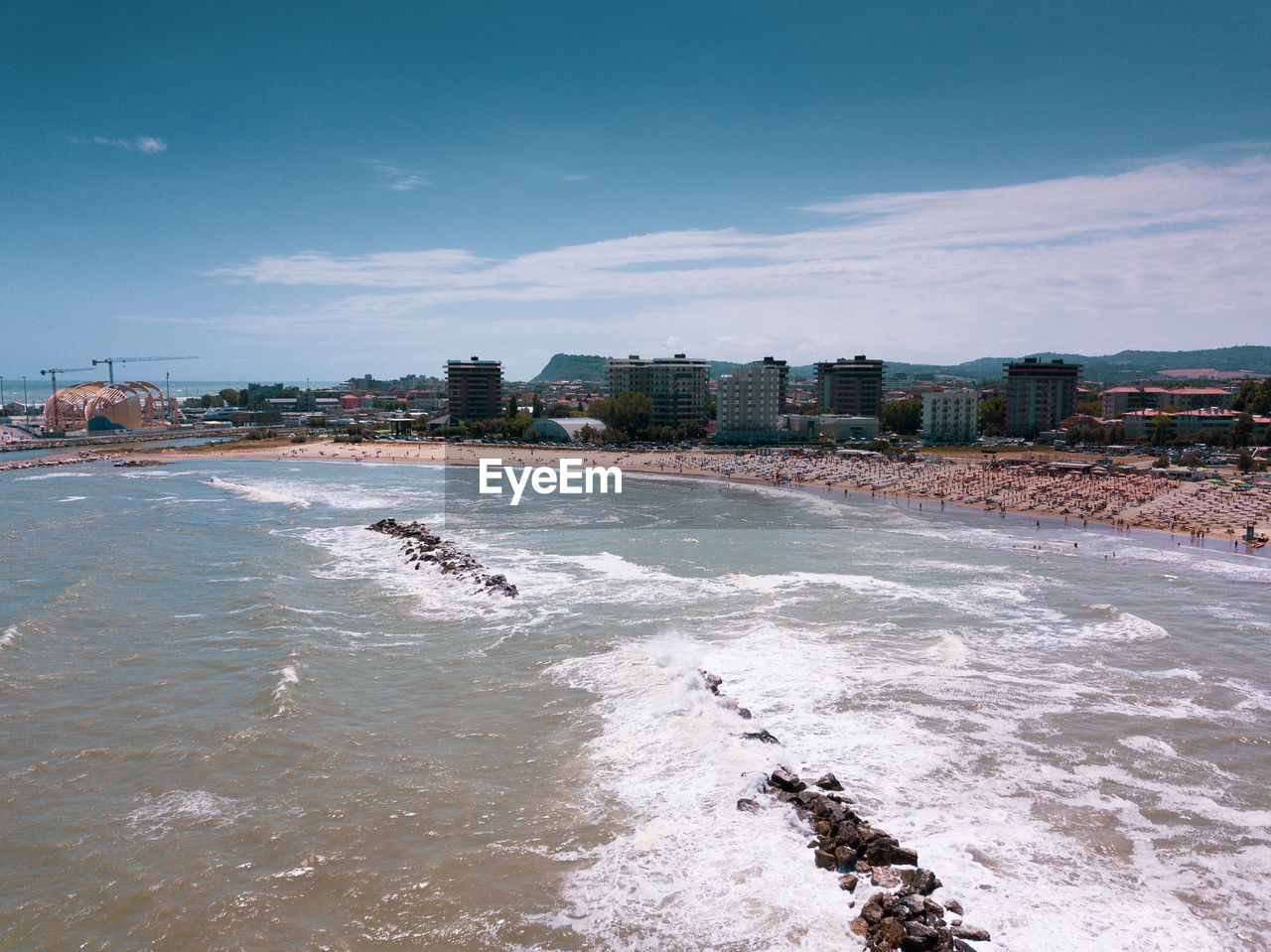 Scenic view of beach and buildings against sky