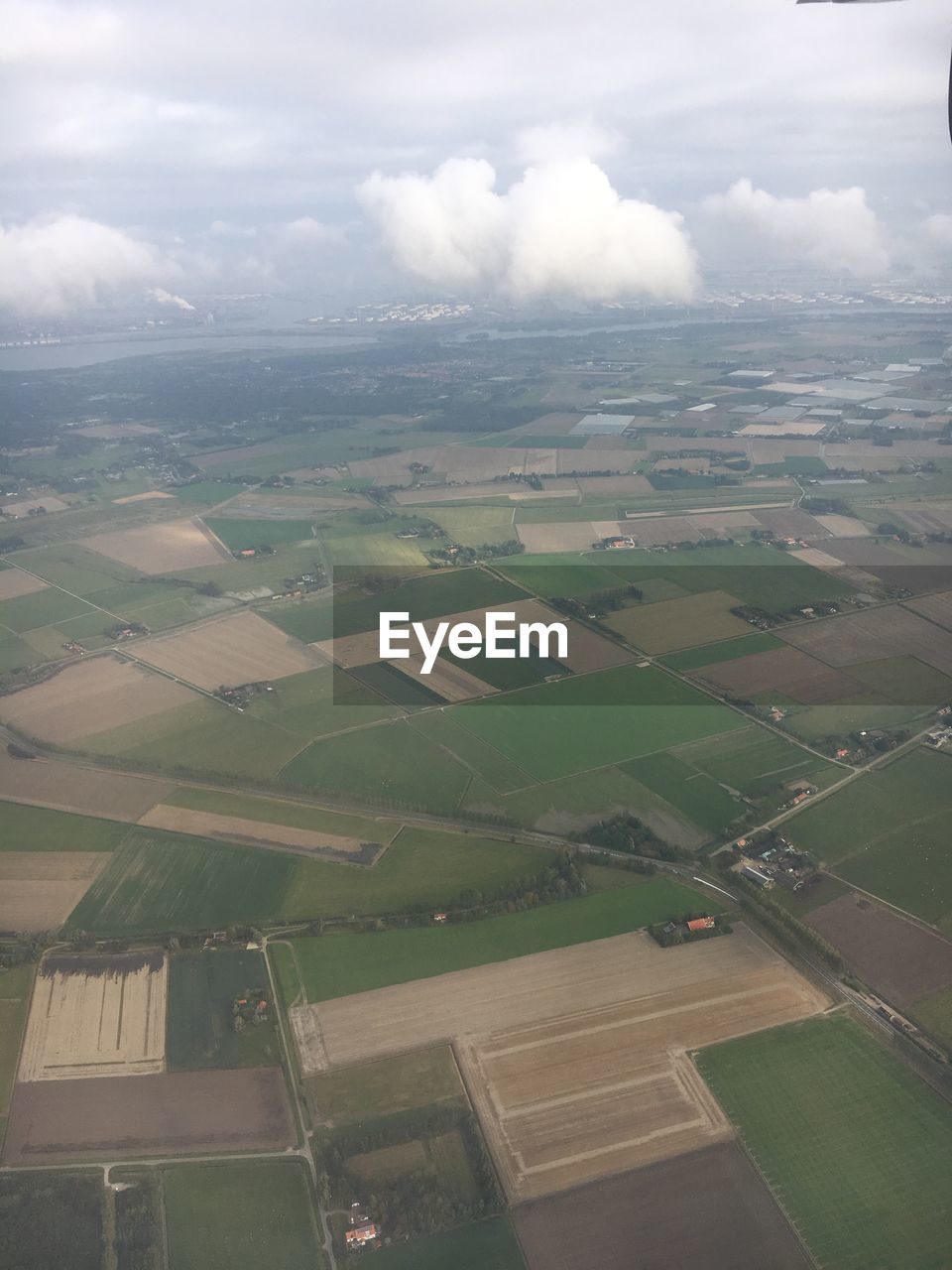 AERIAL VIEW OF AGRICULTURAL LANDSCAPE AGAINST SKY