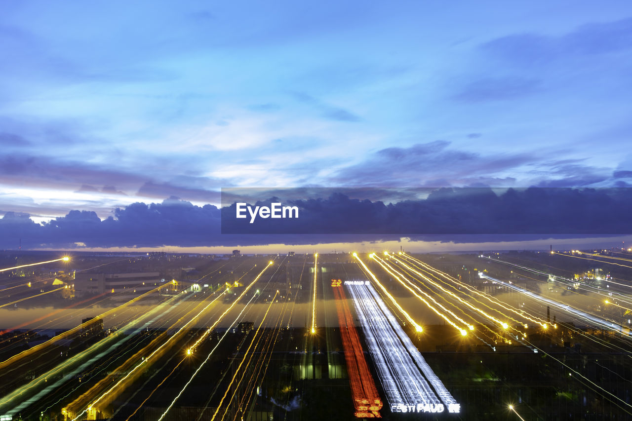 HIGH ANGLE VIEW OF LIGHT TRAILS ON HIGHWAY IN CITY