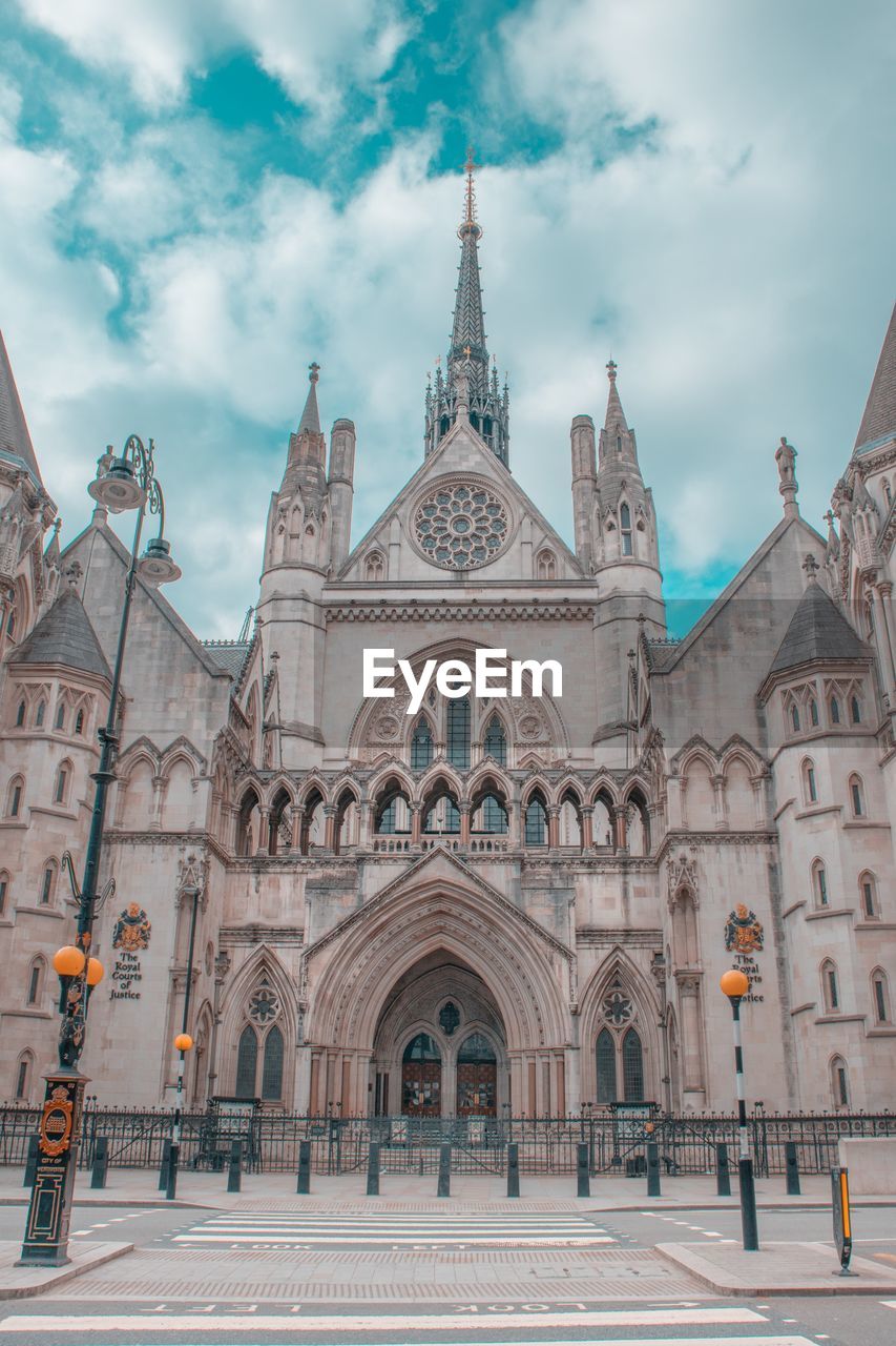 Low angle view of cathedral against cloudy sky in city