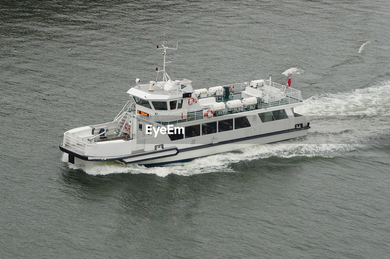 HIGH ANGLE VIEW OF CRUISE SHIP SAILING ON SEA