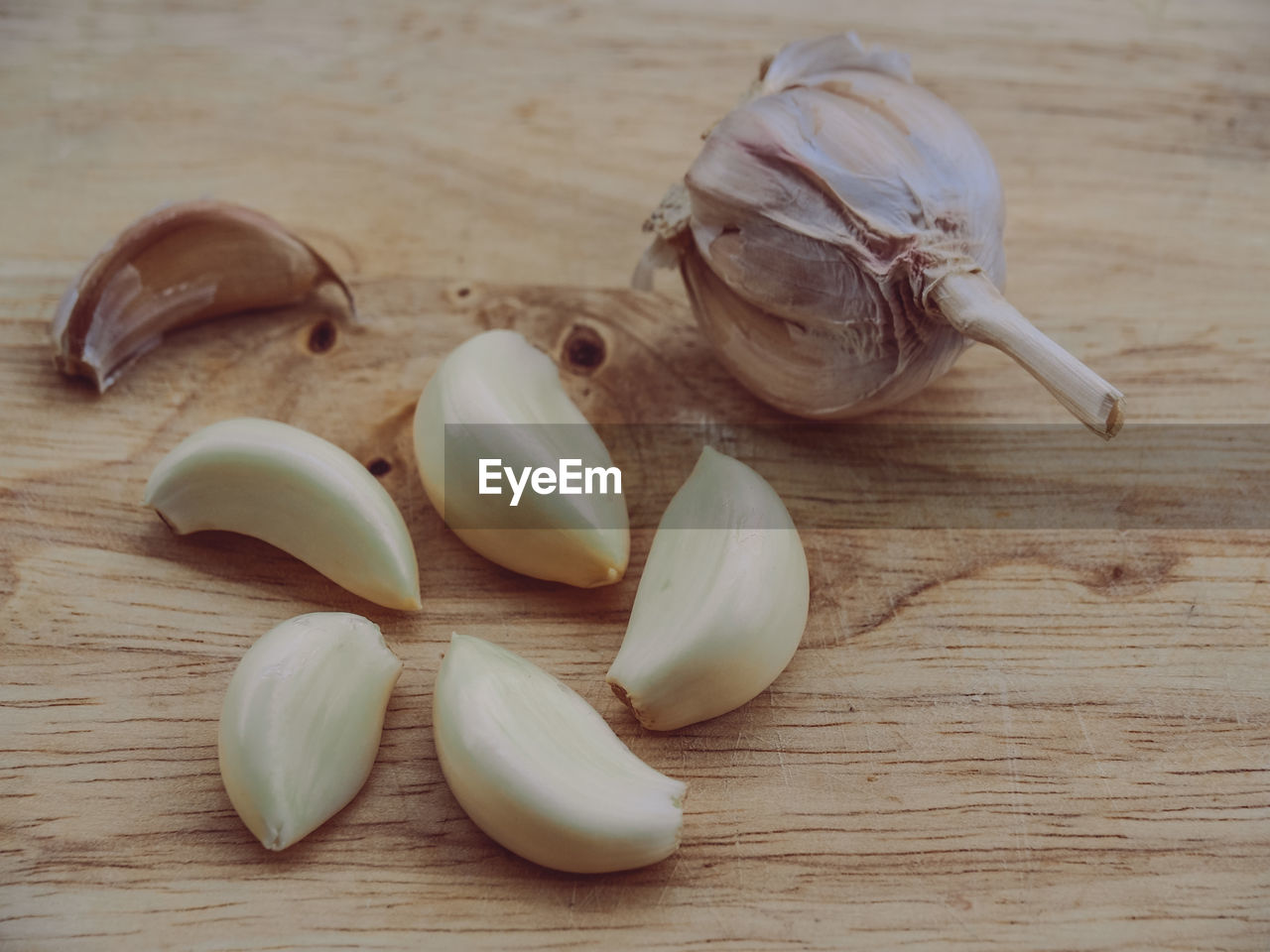 HIGH ANGLE VIEW OF GARLIC ON WOODEN TABLE