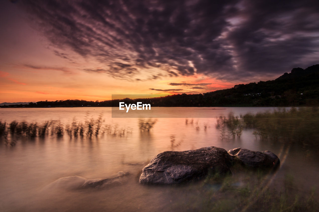 Scenic view of lake against sky during sunset