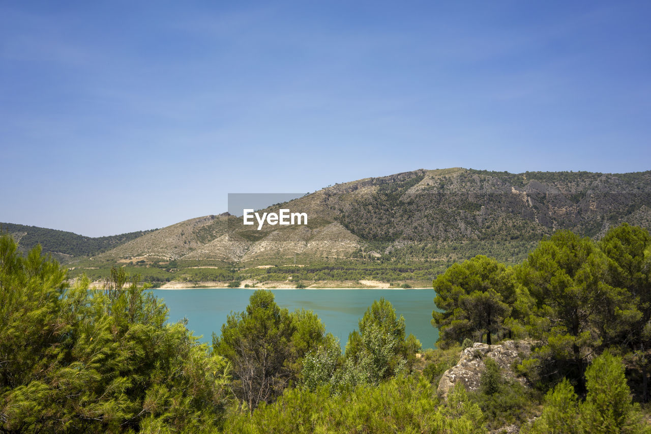 SCENIC VIEW OF LAKE AGAINST BLUE SKY