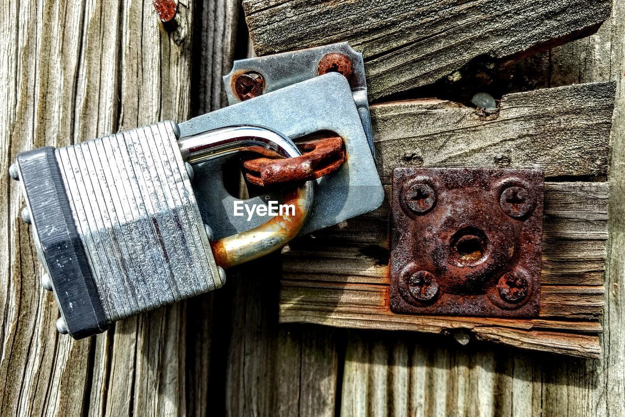 Close-up of padlock on wooden door