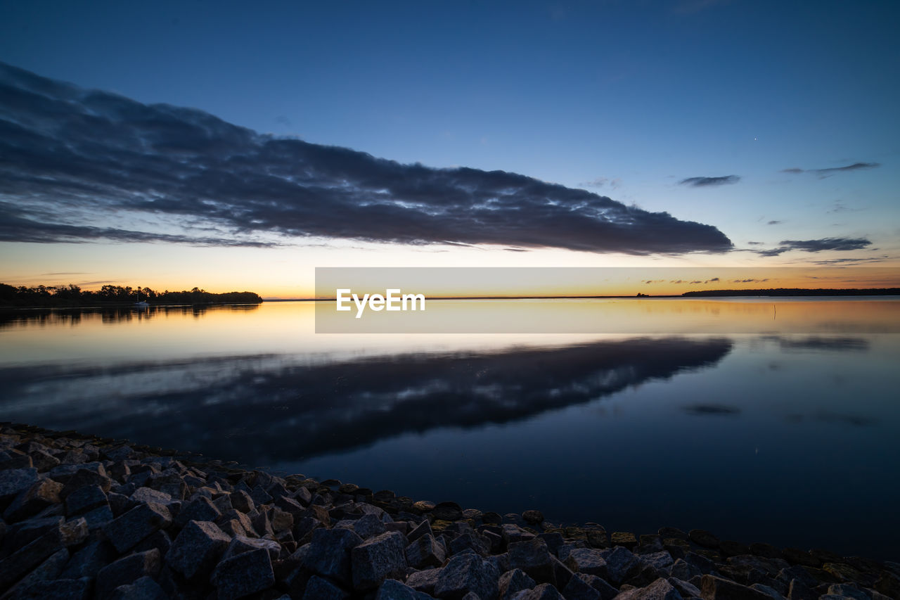 Scenic view of lake against sky during sunset