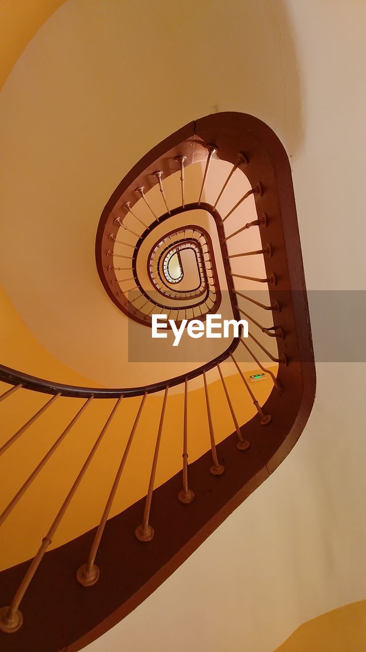 LOW ANGLE VIEW OF SPIRAL STAIRS AGAINST THE SKY